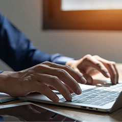 hands typing on laptop